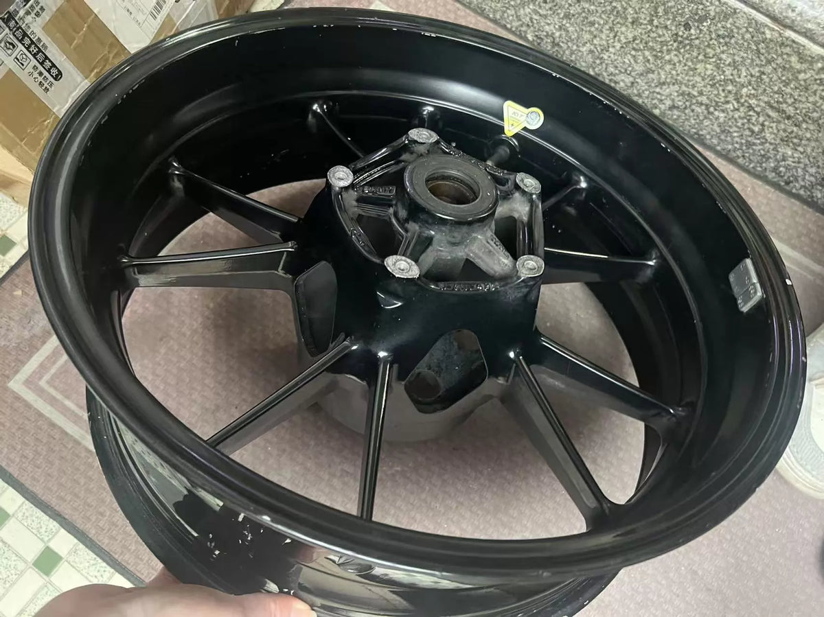 BMW S1000RR rear wheel rim side profile view, hub detail visible, used condition