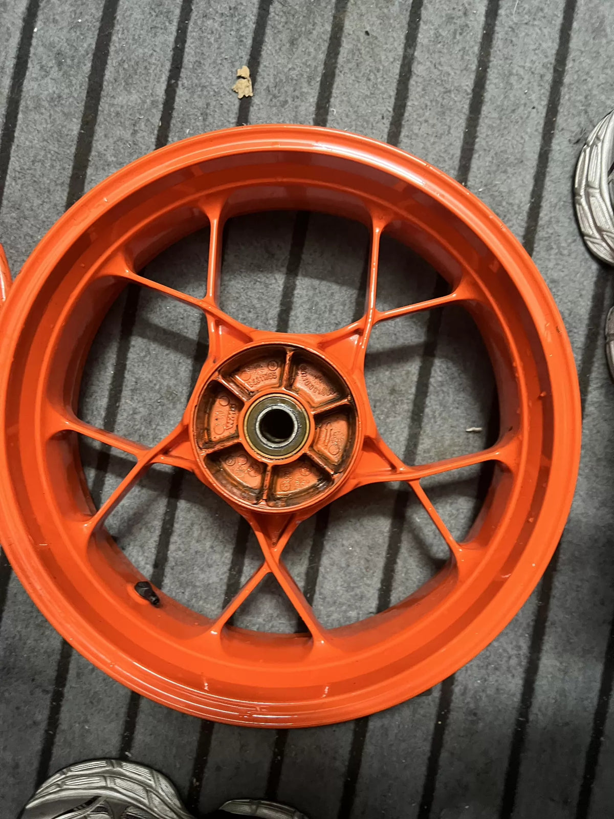 Detail shot of electric motor hub on orange KTM 790 Duke wheel, clean condition