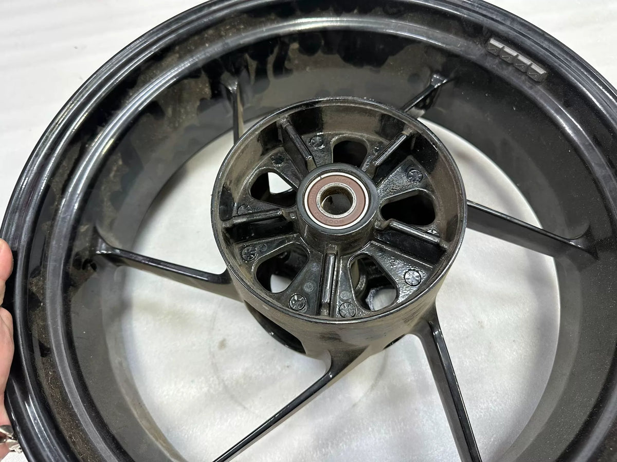OEM Aprilia RS660 rear wheel 5.5x17 angled view highlighting rim edge and valve stem hole