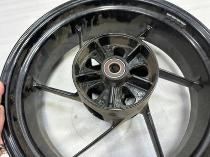 OEM Aprilia RS660 rear wheel 5.5x17 angled view highlighting rim edge and valve stem hole