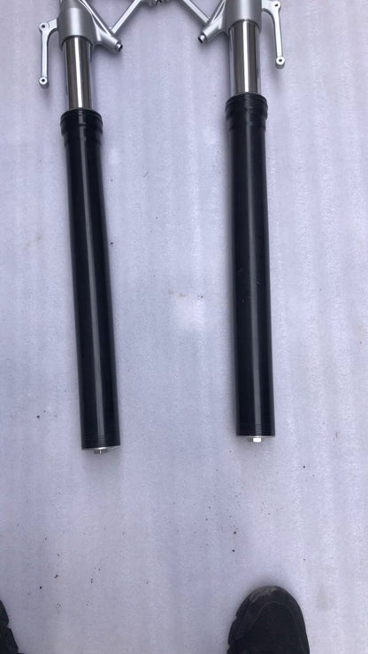 BMW S1000R fork leg lower leg detail showing damper adjusters and drain screw