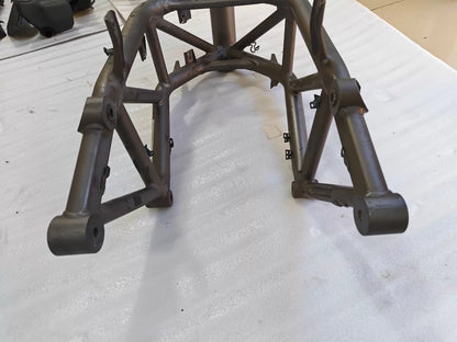 Low angle rear view of grey trellis frame for Ducati MTS1200, swingarm pivot bosses, welds visible, used