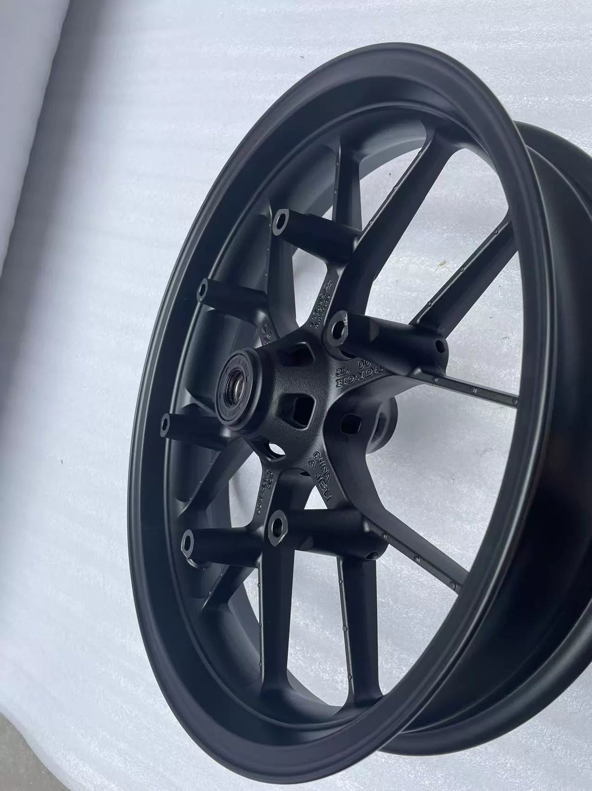 Honda CBR 500R front wheel rim straight, close-up of hub center and axle bore detail