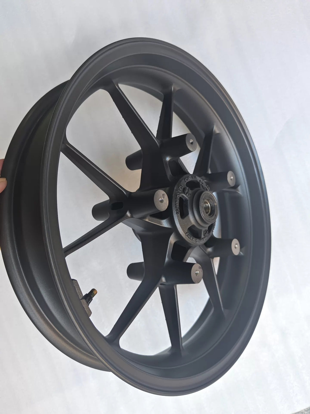 Close-up of Honda CBR 500R front rim inner hub and bearing seat area showing machined aluminum finish