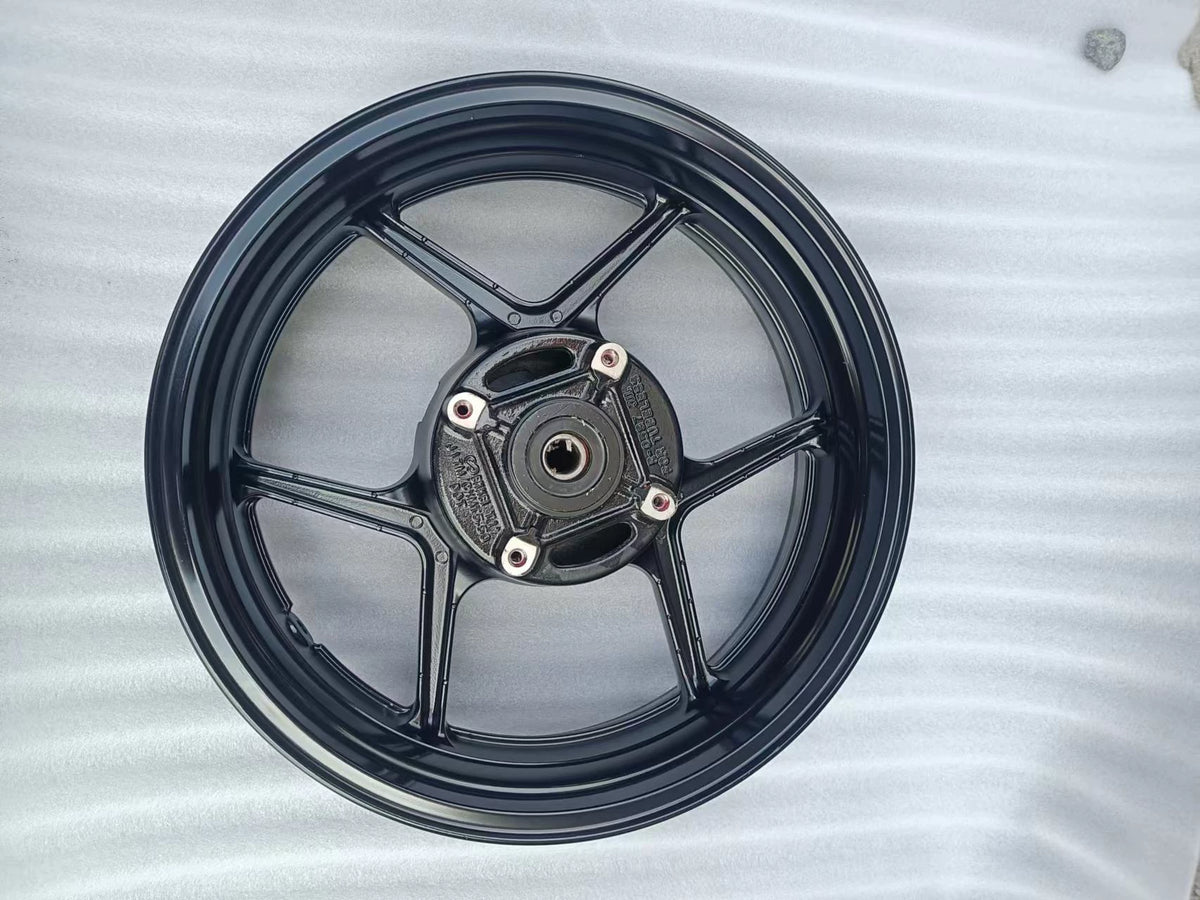 Rear wheel assembly gloss black Kawasaki Z800, close-up of hub center and axle bore detail