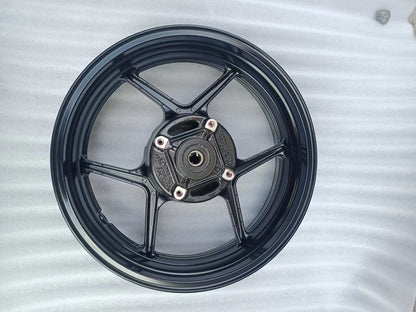 Rear wheel assembly gloss black Kawasaki Z800, close-up of hub center and axle bore detail