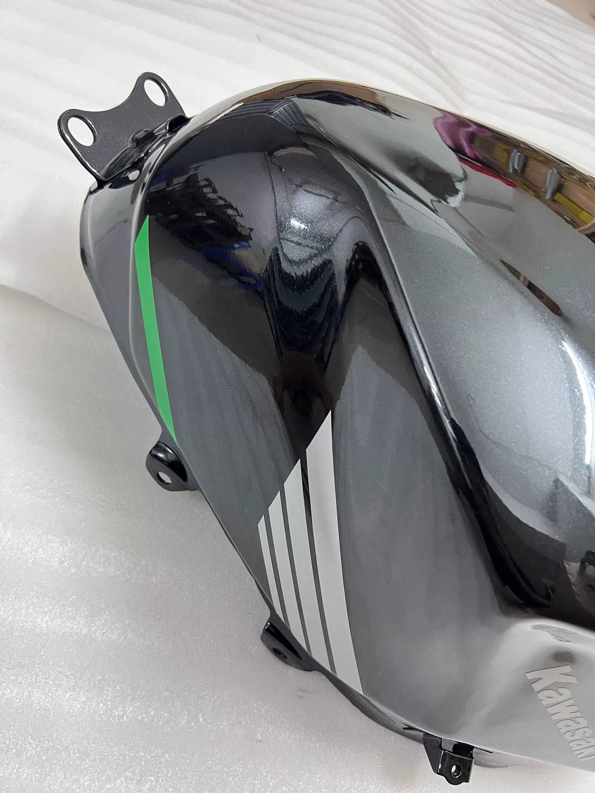 Kawasaki Ninja 400 fuel tank rear angle showing mounting brackets and fuel outlet connections