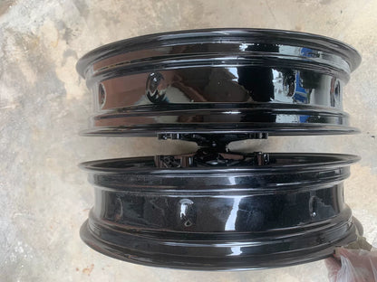 BMW S1000RR wheel set rim edge detail view, clean silver finish and valve stem area