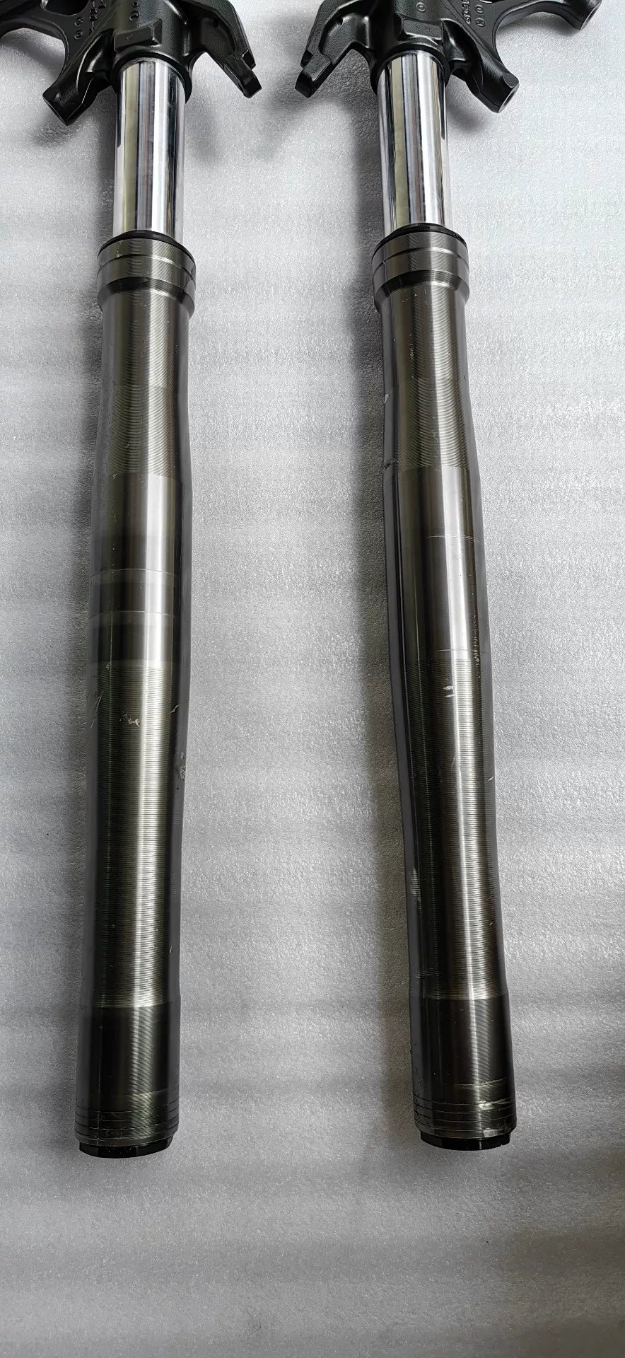 Ducati Panigale V2 front fork tube surface close-up, chrome finish with minor wear inspection