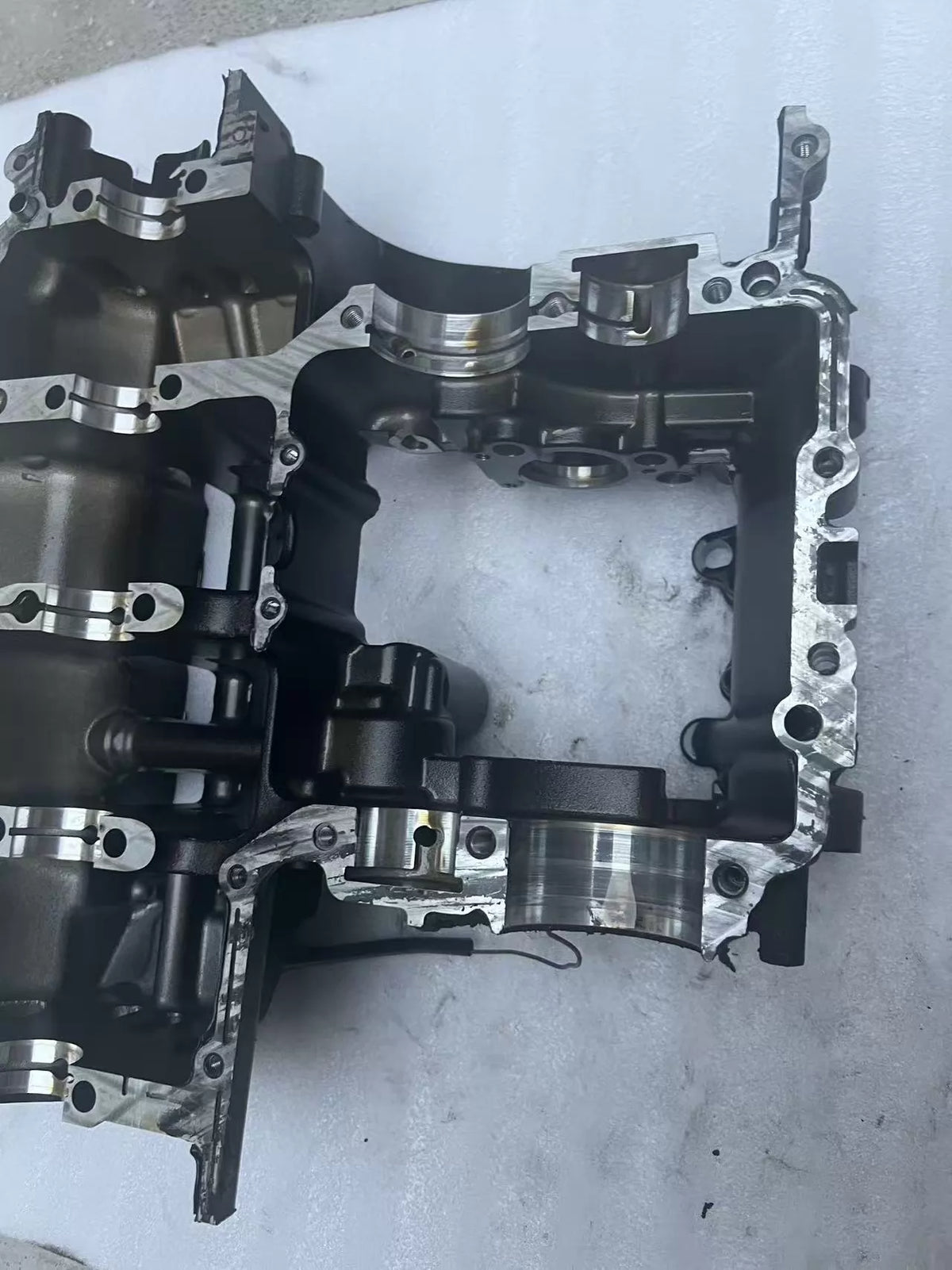 Lower crankcase Kawasaki Z900, bottom view showing drain plug area and ribbed casting structure, used condition