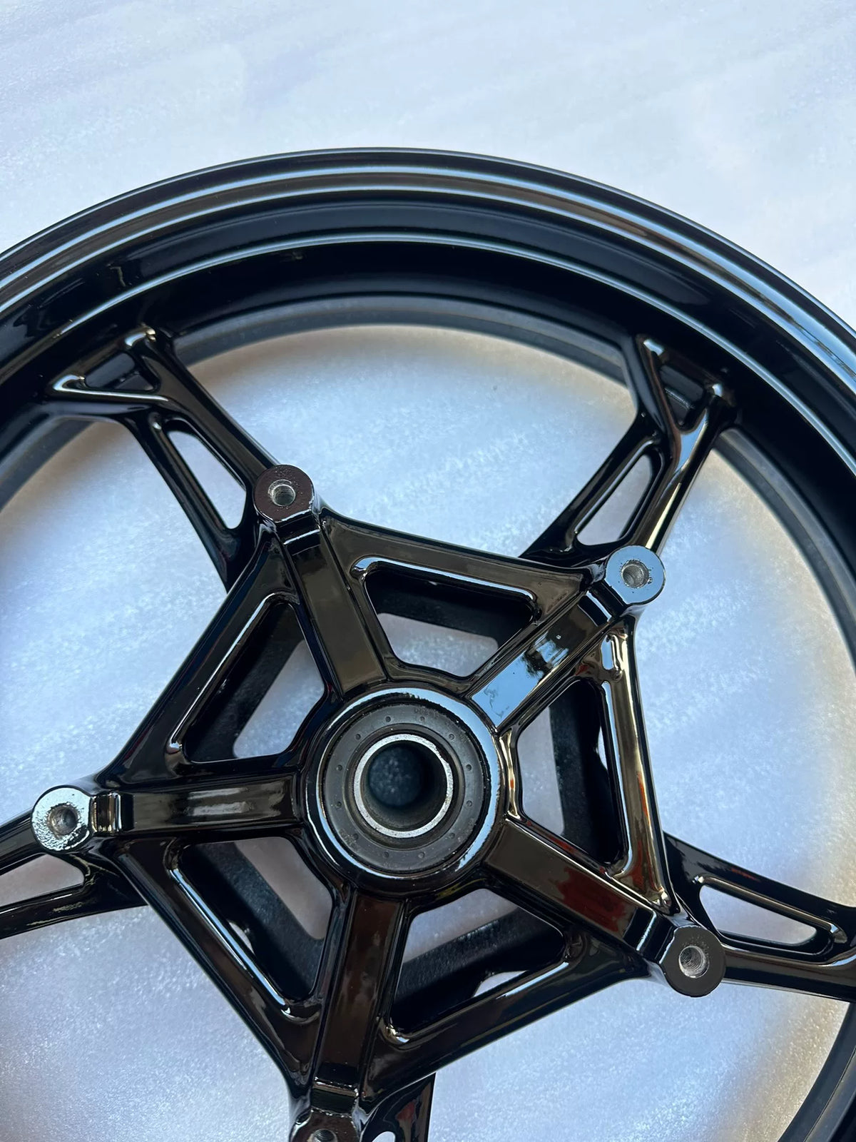 BMW S1000RR front wheel partial angle showing valve stem hole and rim edge condition