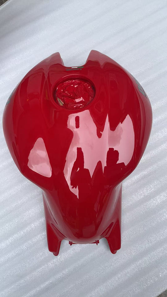 Top view of red Ducati Monster 821 fuel tank showing filler neck opening and glossy paint