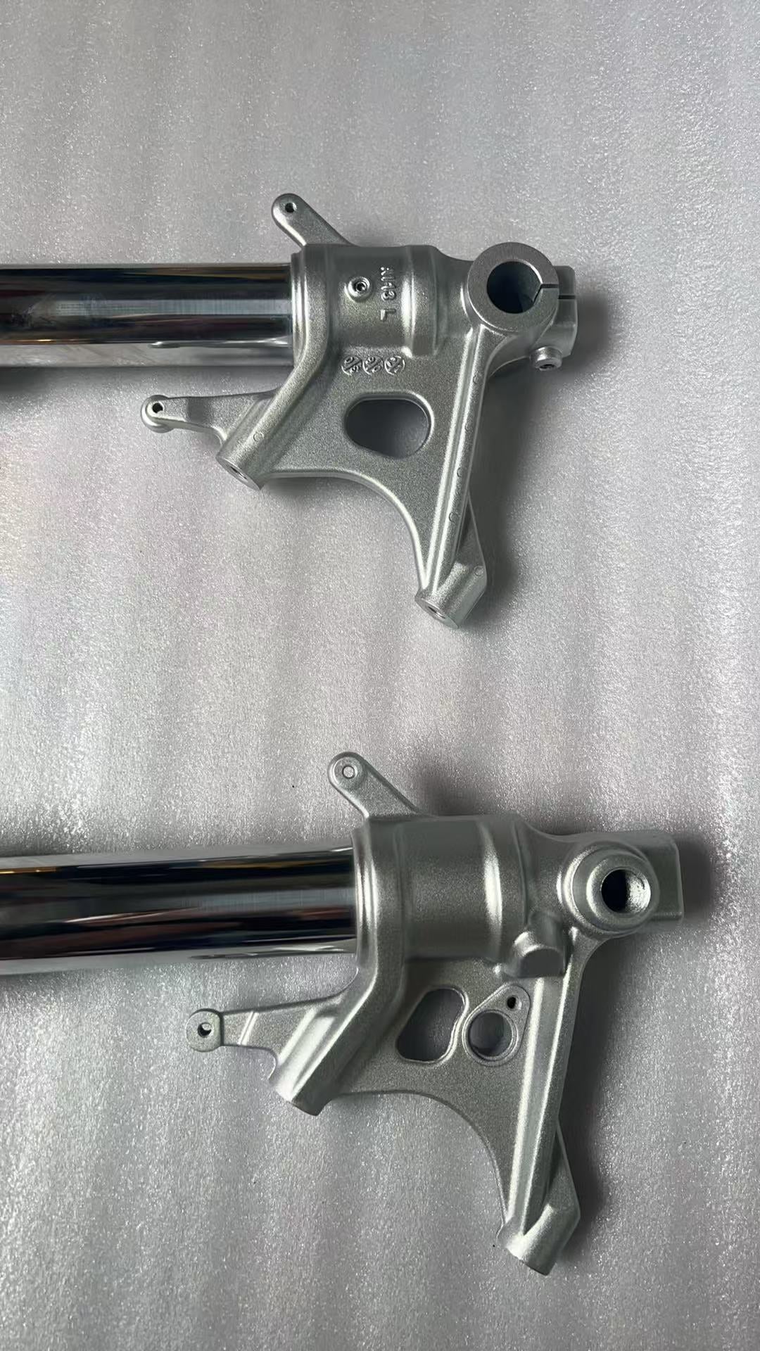 Aprilia RS 660 front fork lower leg detail showing axle clamp and brake caliper mount