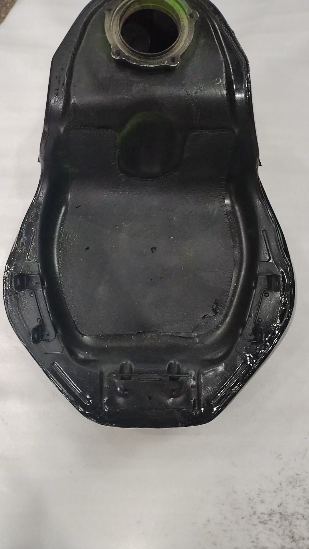 Bottom rear view of ZX6R fuel tank interior underside with seam welds and mount tabs