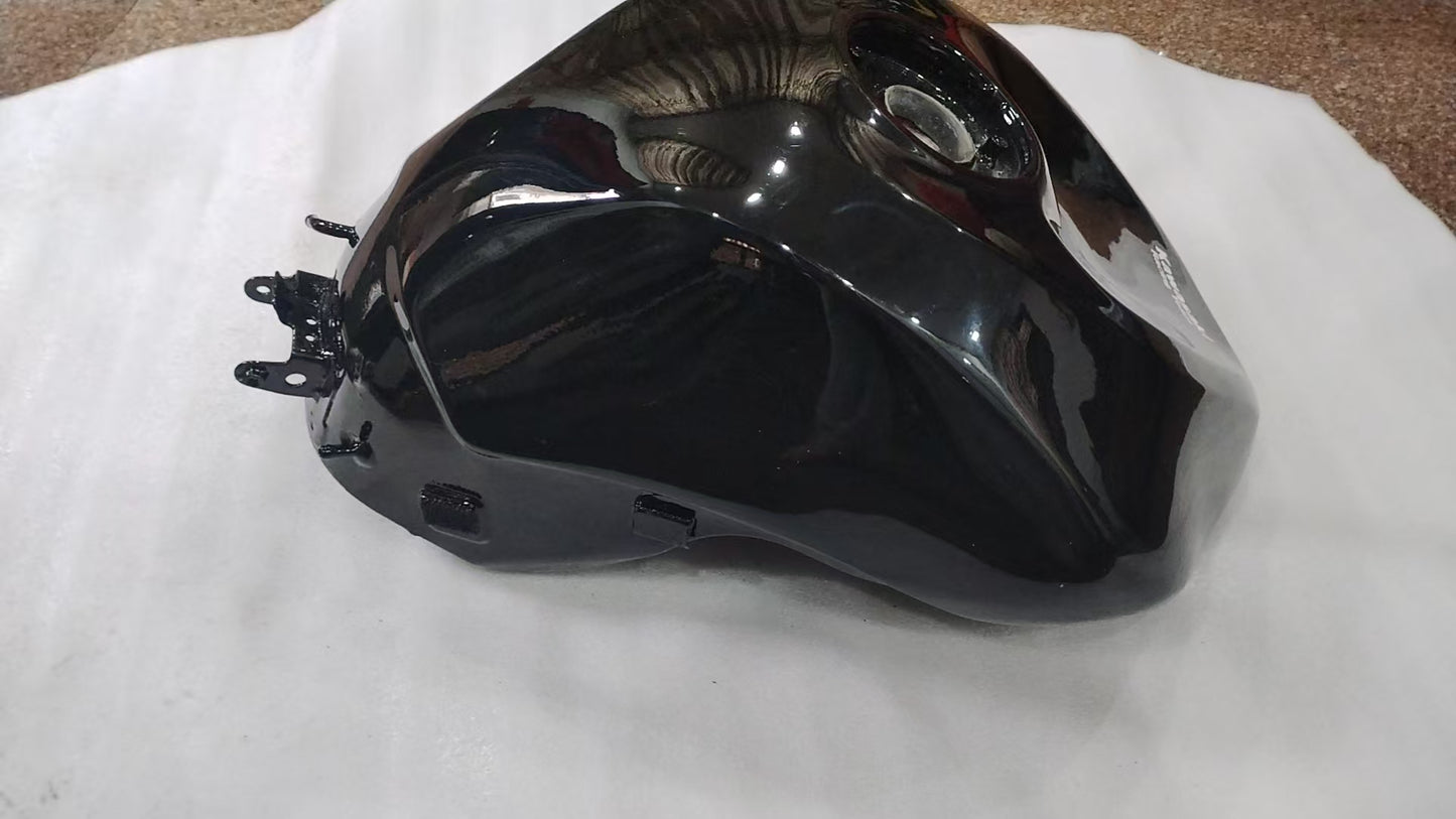 Angled side view of glossy black ZX6R fuel tank showing smooth painted surface and front brackets