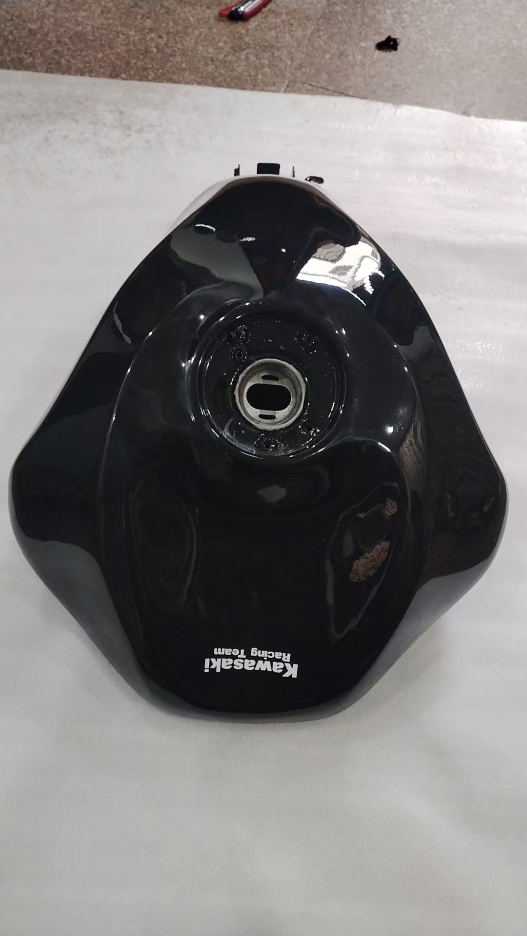 Top view of black Kawasaki Racing Team fuel tank with filler neck opening, ZX6R