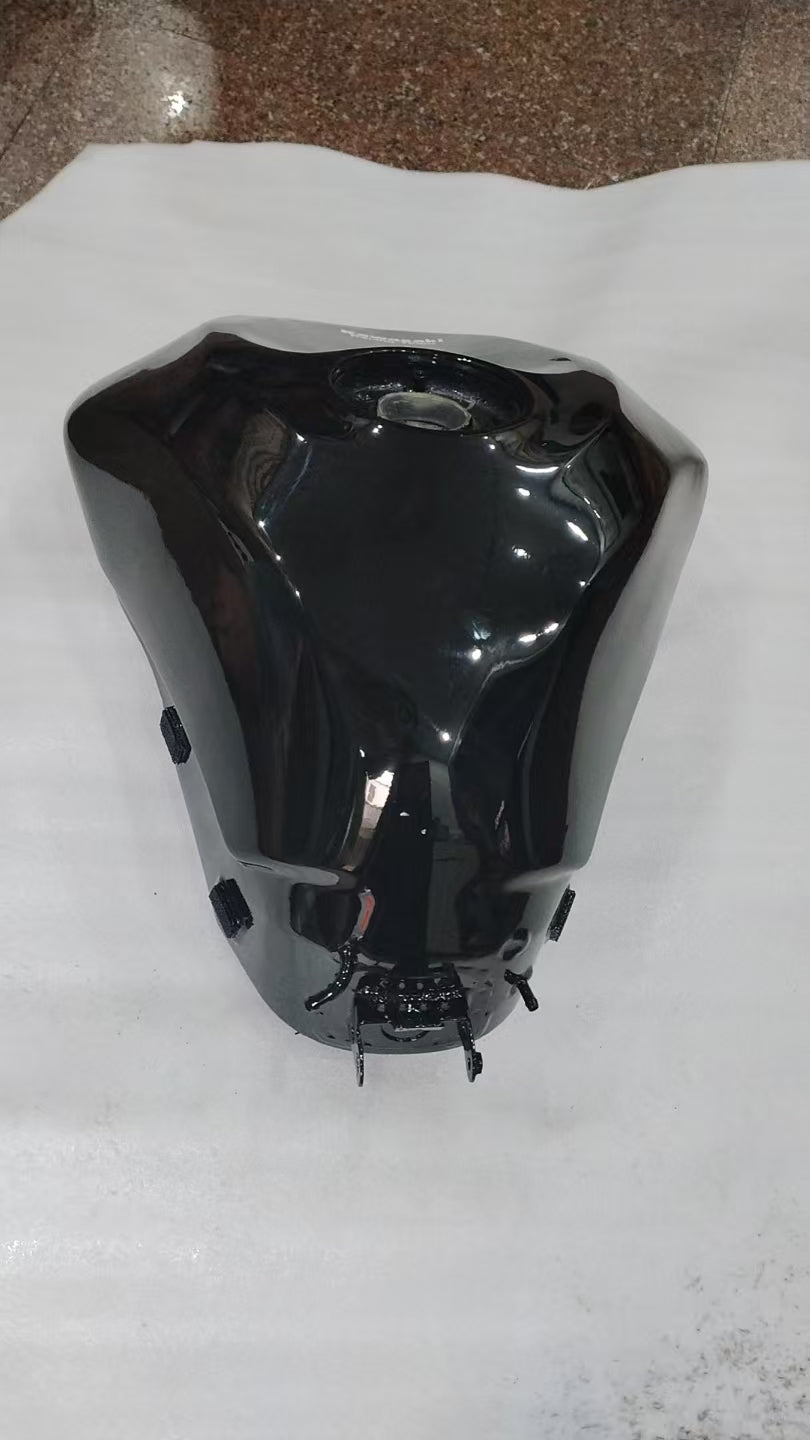 Rear angle of black Kawasaki ZX6R fuel tank showing filler cap recess and mounting tabs