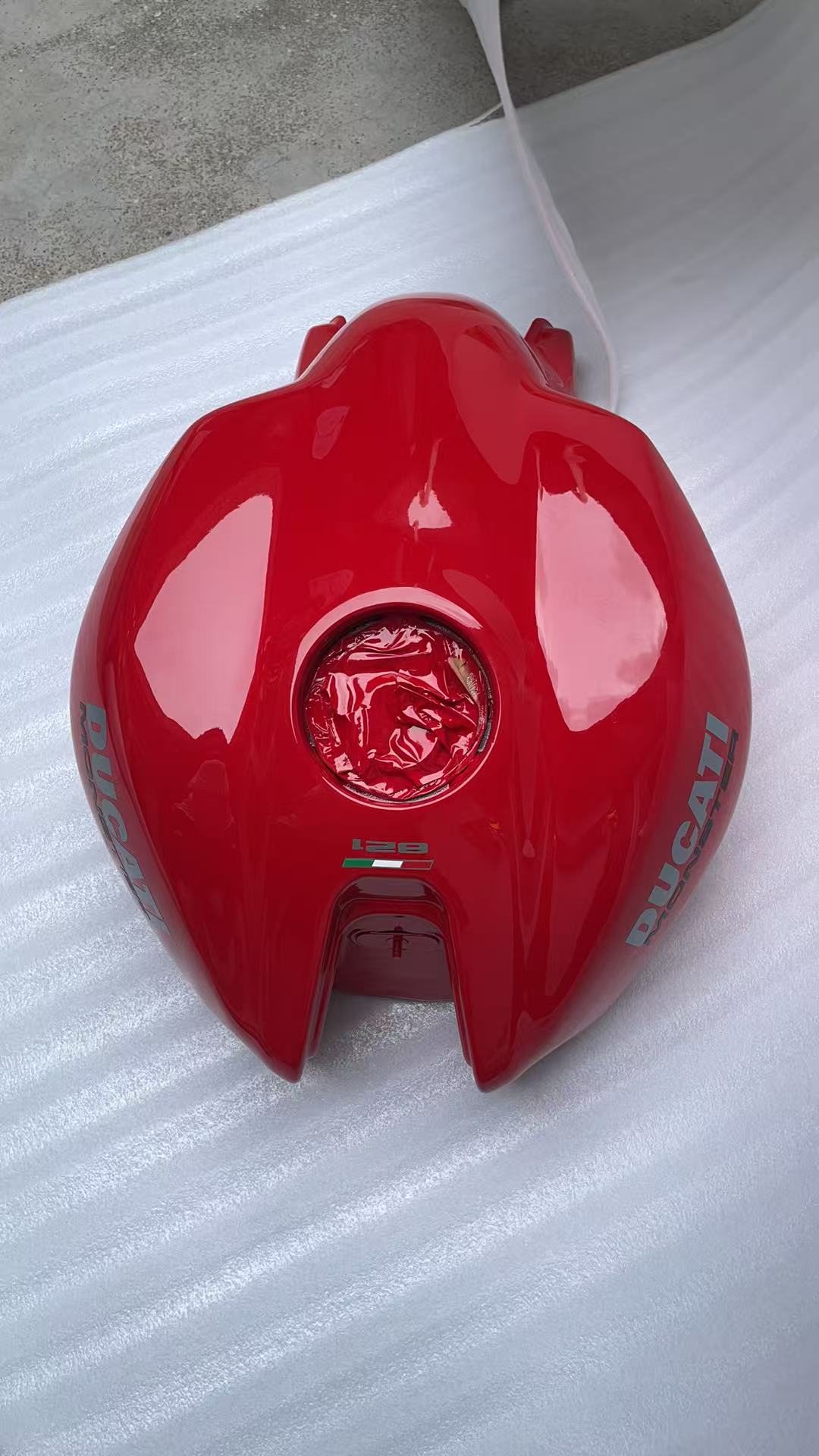 Top-down view of red Ducati Monster 821 tank with fuel cap opening, DUCATI decals and Italian flag 821 badge