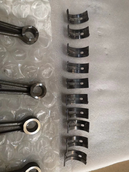 YZF-R1 crankshaft connecting rods and row of main bearing shells laid out on bubble wrap, close view