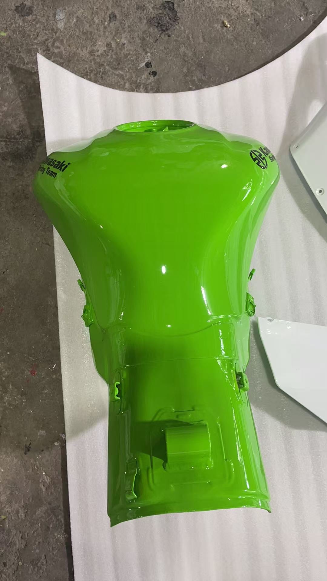 Top view of lime green ZX10R fuel tank with Kawasaki Racing Team decals, glossy repaint, filler neck open