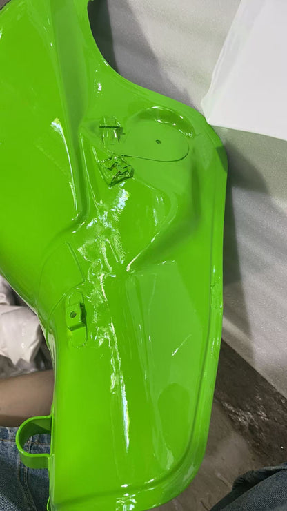Left flank close-up of ZX10R green tank showing recessed pump plate area, bracket tab and glossy finish