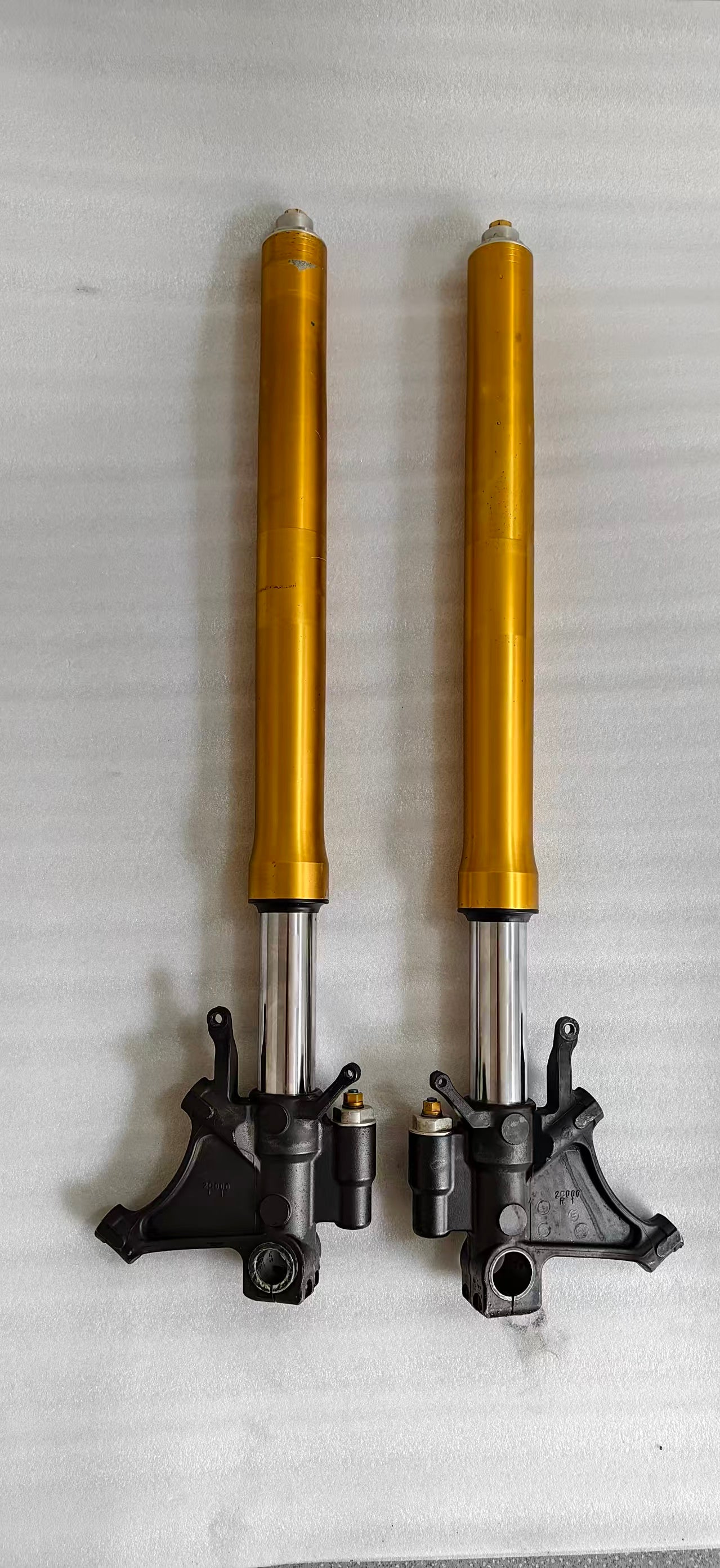 Both YZF-R6 front forks upright, gold uppers and chrome sliders, showing axle brackets and preload adjusters
