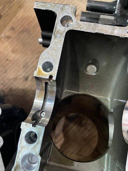 Detail of YZF-R6 crankcase corner showing threaded holes and main bearing shell seam