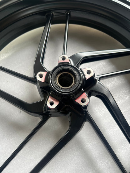 Ducati Monster 821 front wheel, close-up of hub center and axle area, used condition visible