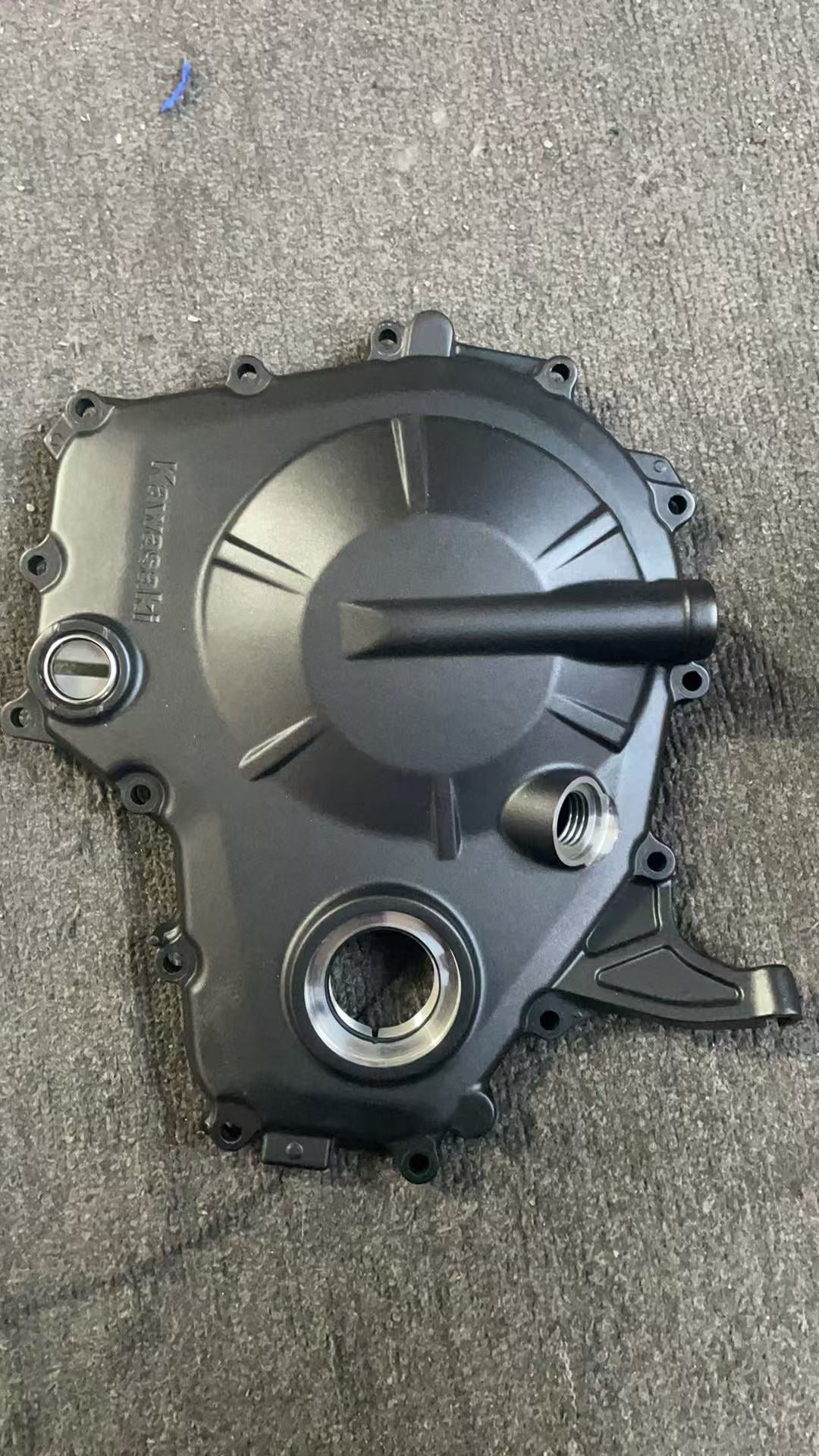 Full outer face of black clutch cover for Ninja ZX-4R, Kawasaki logo, filler neck and inspection plug, good shape