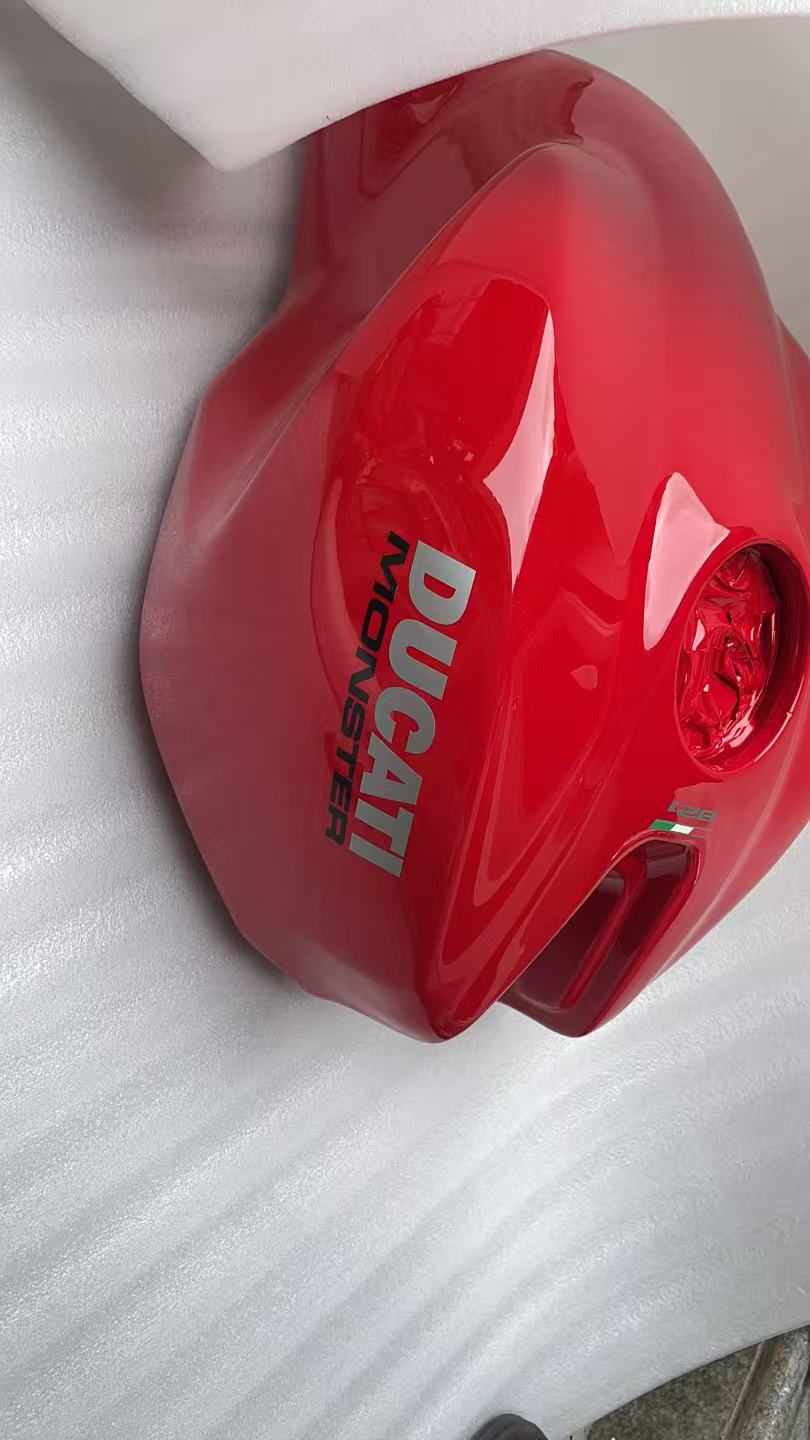 Front angled view of red Ducati Monster 821 tank showing fuel cap area and DUCATI MONSTER logo