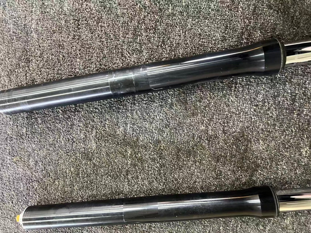 Yamaha YZF-R6 2008-2016 fork mid-sections close-up, black tubes with slight scuffing on carpet