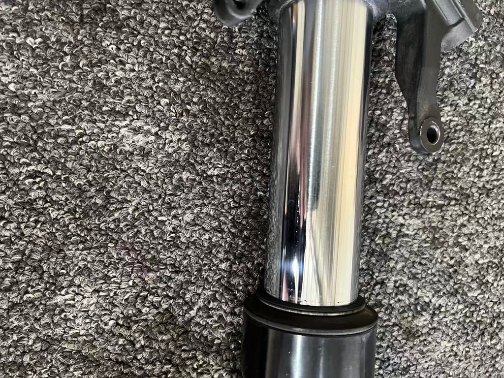 Yamaha YZF-R6 front fork chrome slider tube close-up, polished reflective surface with light scratches, 08-16
