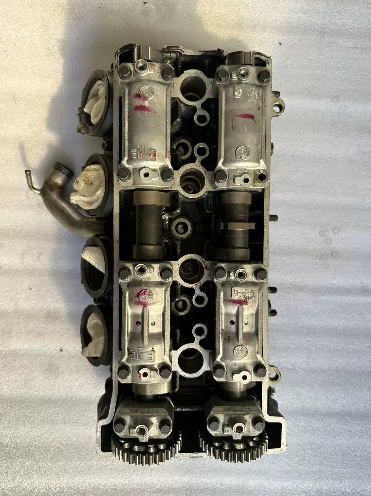 Top valvetrain view of Yamaha YZF-R1 cylinder head, dual camshafts, cam caps and sprockets, used
