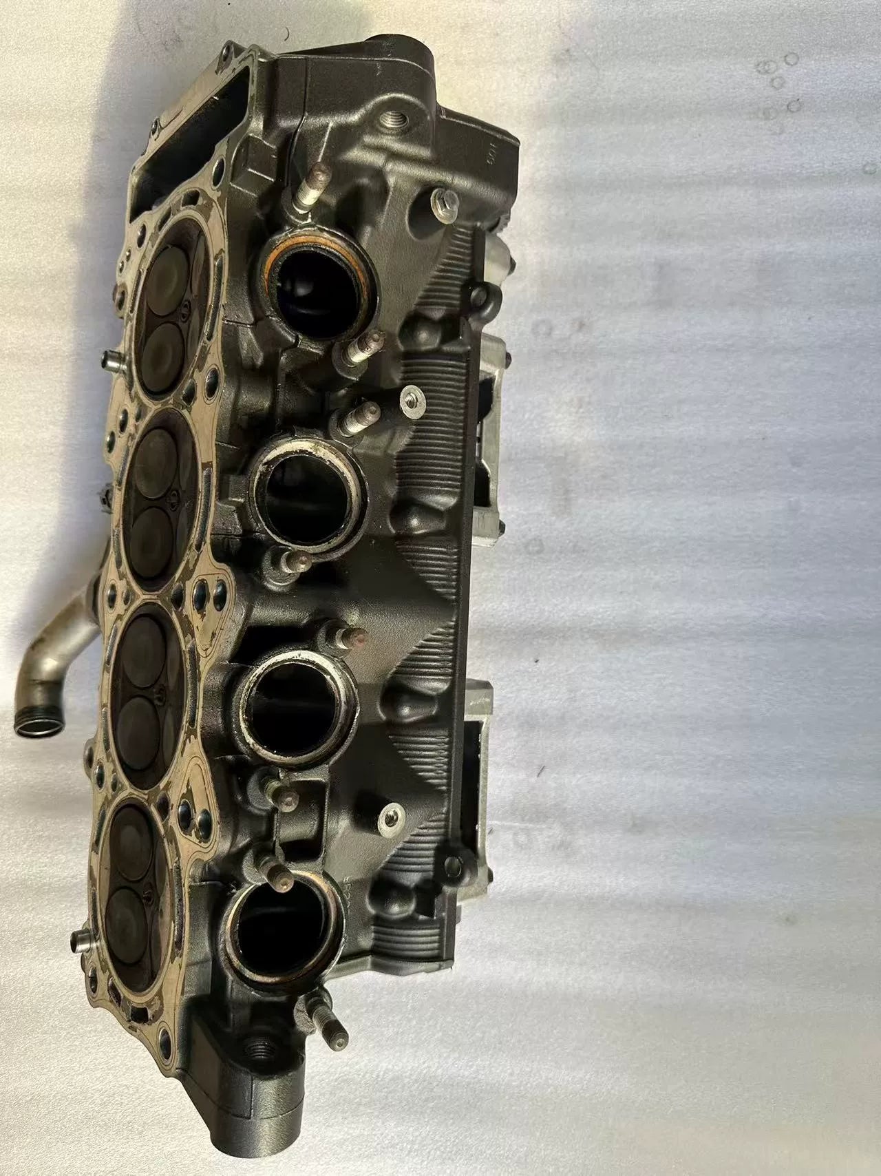 Combustion chamber side of Yamaha YZF-R1 cylinder head, 4 intake ports and valve faces visible, used