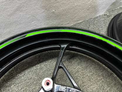 Kawasaki Ninja 650 front wheel hub bearing repainted gloss black green stripe close-up
