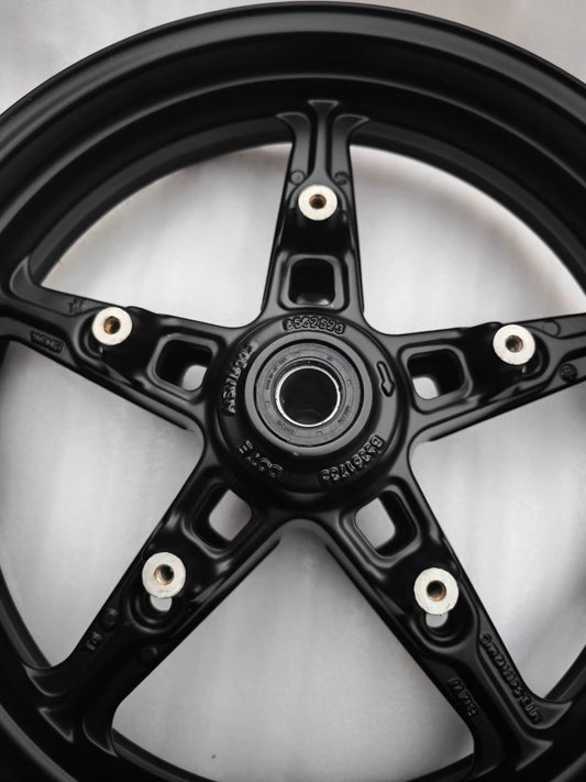 Close-up of black 5-spoke cast front rim hub with bearing and part number for BMW R NineT