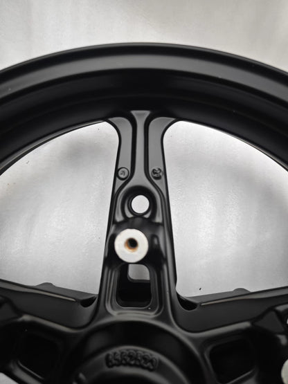 Close-up of black cast front rim spoke and inner barrel with valve hole, BMW R NineT