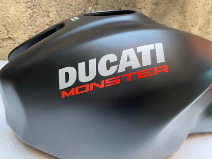 Ducati Monster 821 OEM fuel tank repainted red, front three-quarter angle view showing smooth finish