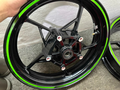 Kawasaki Ninja 650 front wheel hub bearing repainted gloss black green stripe close-up
