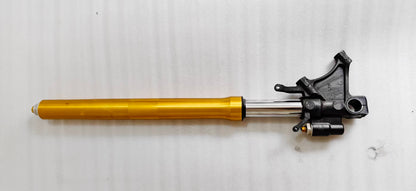 Horizontal YZF-R6 front fork, gold tube and black axle bracket, showing caliper mount and preload bolt