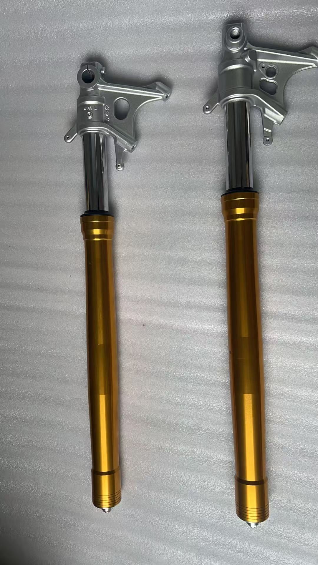 Aprilia RS 660 front fork pair laid flat, full length overhead view showing both legs
