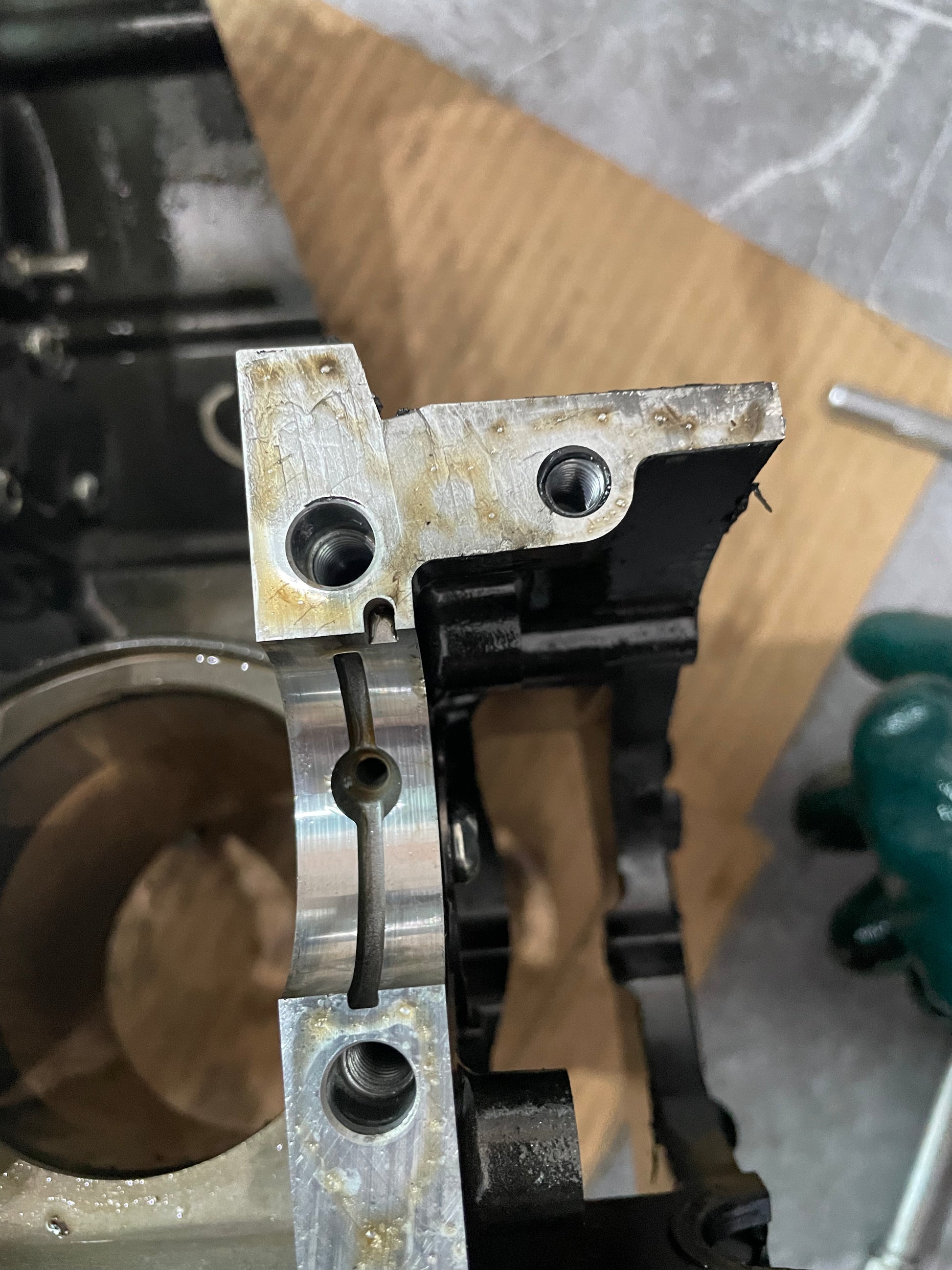 Close-up of YZF-R6 crankcase threaded bolt bosses and bearing cap with cylinder bore behind