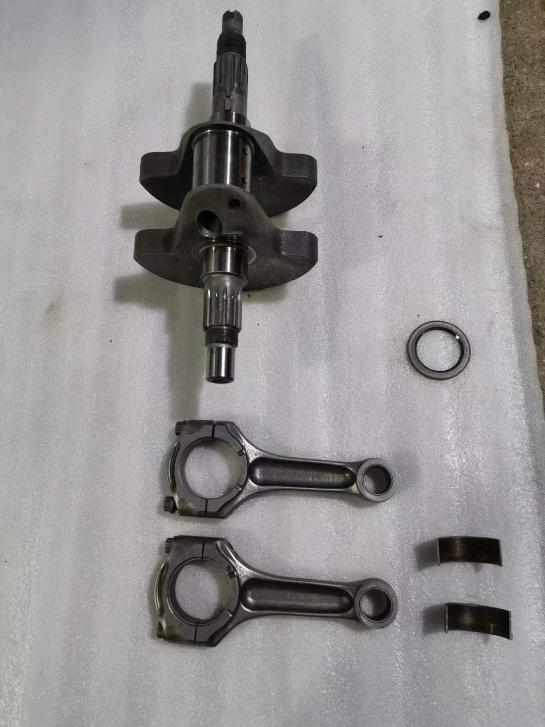 Ducati 848 crankshaft set full view, all components laid out including crank and conrods, clean used condition